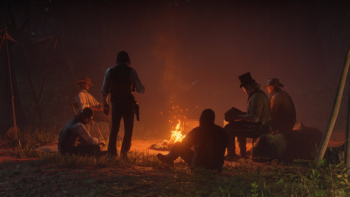 A group of men sit around a campfire