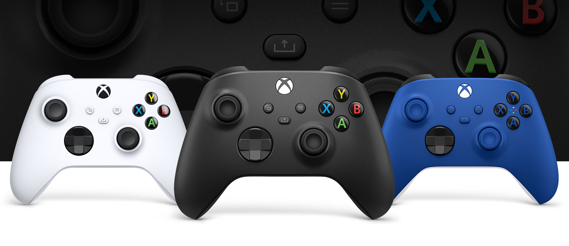 Xbox Carbon Black controller in front with the robot white and shock blue beside it