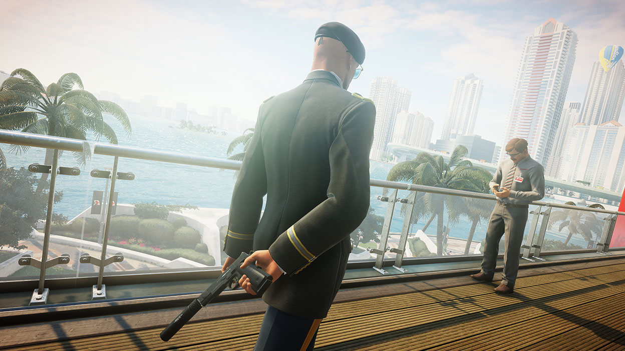 Back view of Agent 47 standing near a racetrack worker in a suit and tie