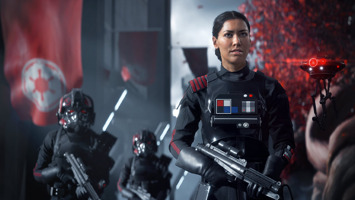 Iden Versio standing outside with her drone hovering next to her.