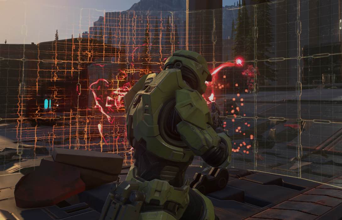 Master Chief shooting at a shield