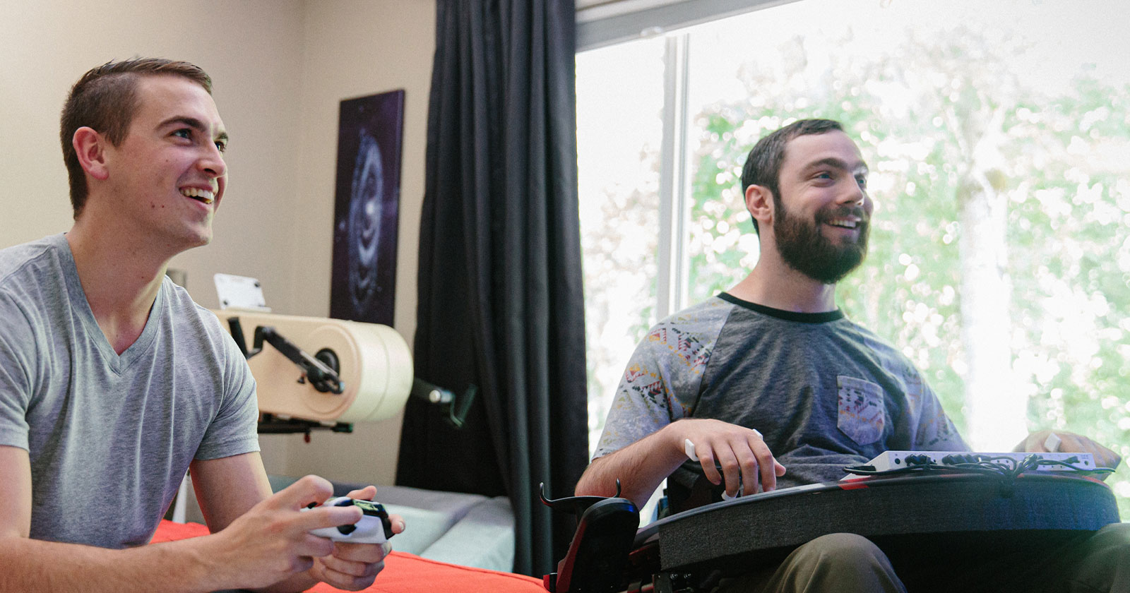 Spencer Allen plays a game with his friend using the Xbox Adaptive Controller.